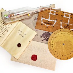 Message in a bottle, letter, treasure map, turntable, hieroglyphics, notebook, driftwood